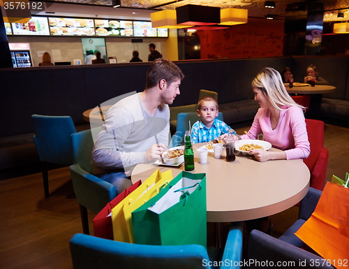 Image of family having lunch in shopping mall