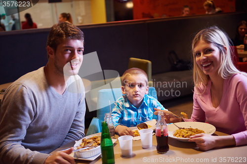 Image of family having lunch in shopping mall