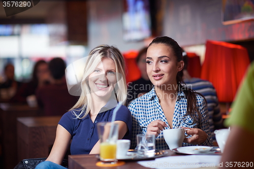 Image of girls have cup of coffee in restaurant