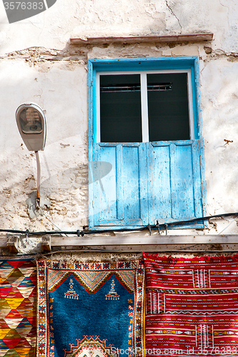 Image of blue window in   africa old  brown wall red carpet