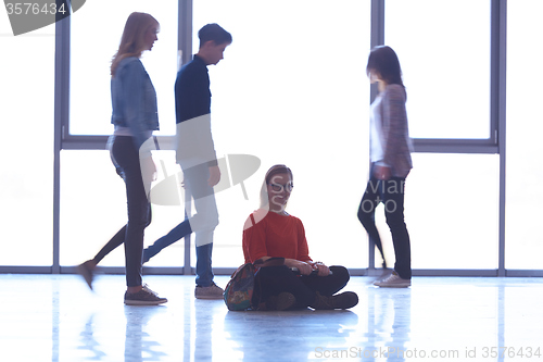Image of student girl standing with laptop, people group passing by