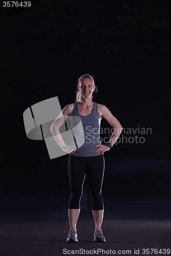 Image of woman  stretching before morning jogging