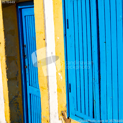 Image of old door in window  and wall ornate   blue