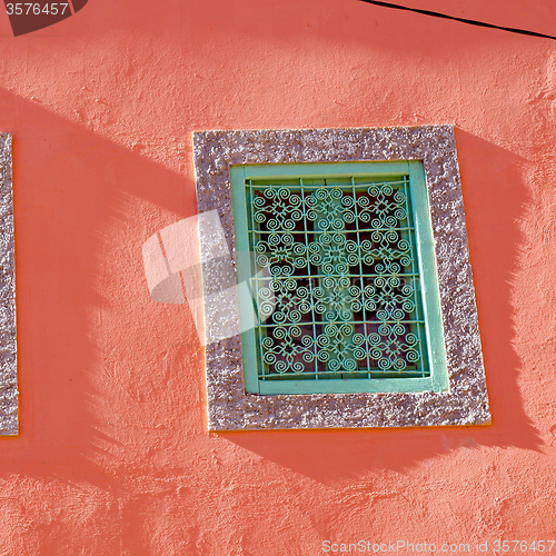 Image of pink  window in morocco africa old construction and brown wall  