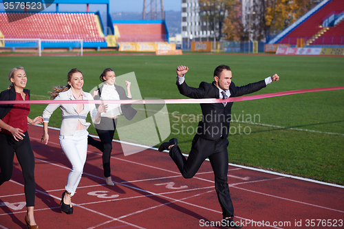 Image of business people running on racing track