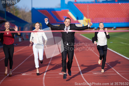 Image of business people running on racing track