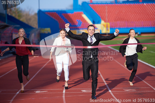 Image of business people running on racing track