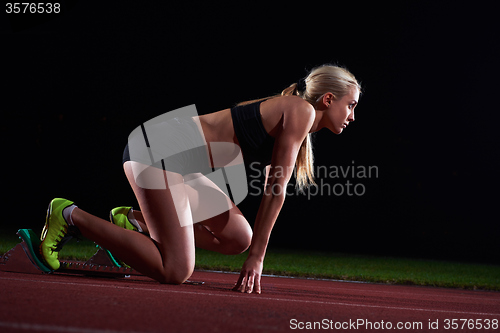 Image of pixelated design of woman  sprinter leaving starting blocks