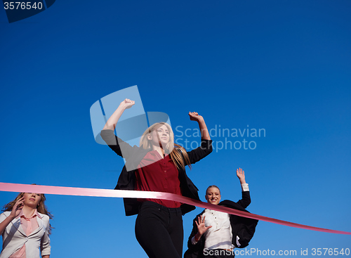 Image of business people running on racing track