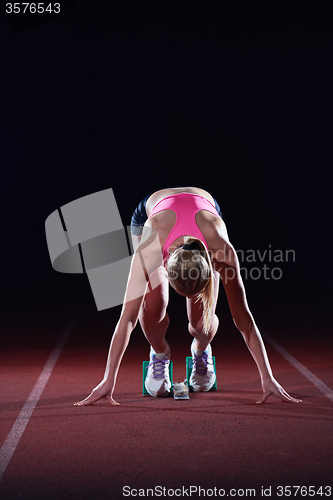 Image of pixelated design of woman  sprinter leaving starting blocks