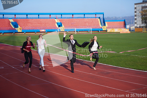 Image of business people running on racing track