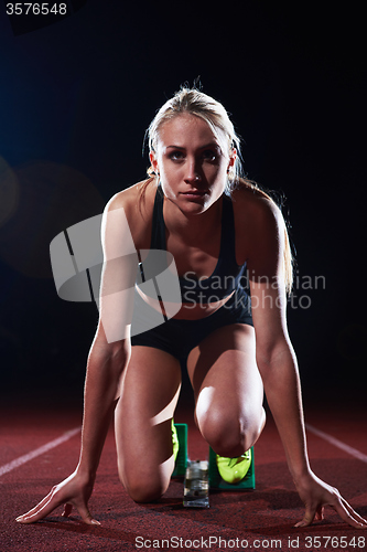 Image of pixelated design of woman  sprinter leaving starting blocks