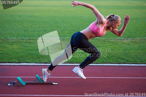 Image of pixelated design of woman  sprinter leaving starting blocks