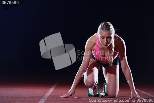 Image of pixelated design of woman  sprinter leaving starting blocks