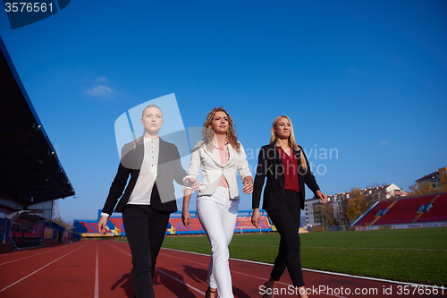 Image of business people running on racing track