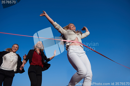 Image of business people running on racing track