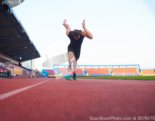 Image of pixelated design of woman  sprinter leaving starting blocks