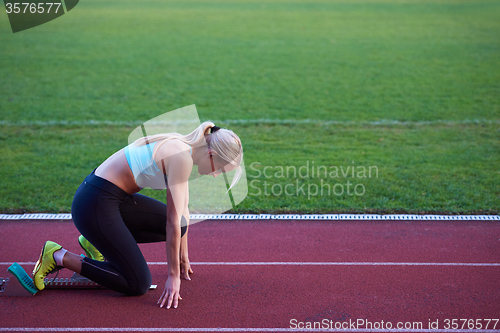 Image of pixelated design of woman  sprinter leaving starting blocks