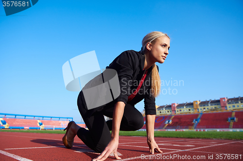 Image of business woman ready to sprint