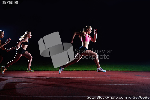 Image of athletic runners passing baton in relay race