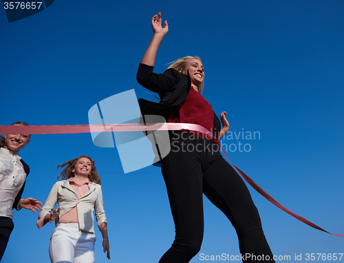 Image of business people running on racing track