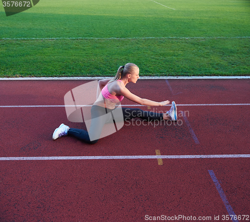 Image of sporty woman on athletic race track