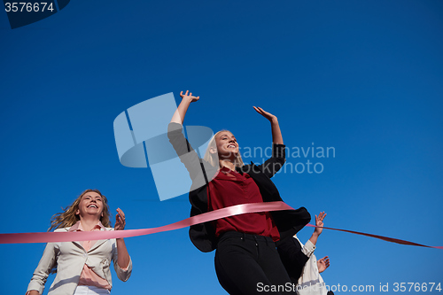 Image of business people running on racing track