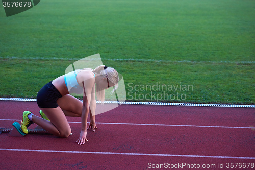 Image of pixelated design of woman  sprinter leaving starting blocks