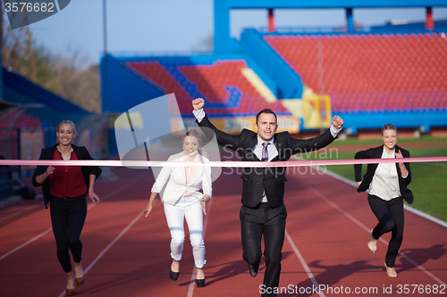 Image of business people running on racing track