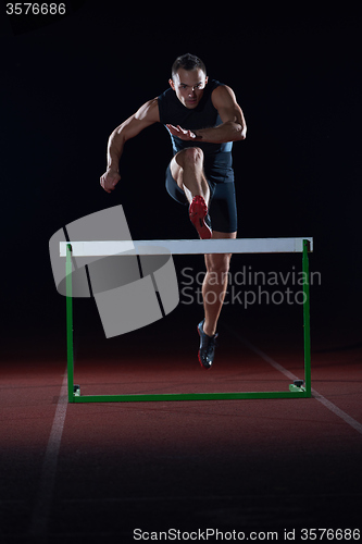 Image of athlete jumping over a hurdles