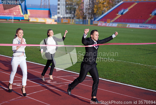 Image of business people running on racing track