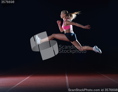 Image of Athletic woman running on track