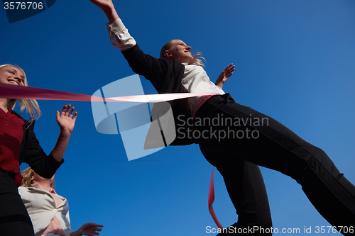 Image of business people running on racing track