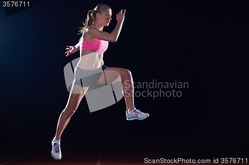 Image of Athletic woman running on track