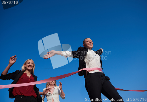 Image of business people running on racing track