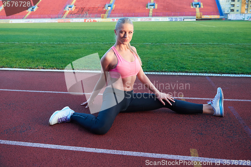 Image of sporty woman on athletic race track