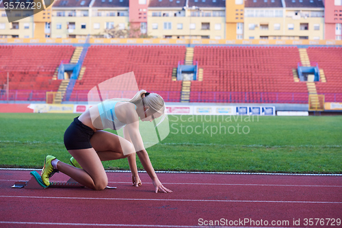 Image of pixelated design of woman  sprinter leaving starting blocks