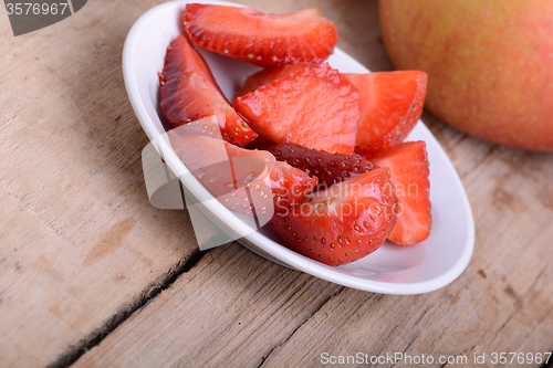 Image of Strawberry slices and apple, closeup