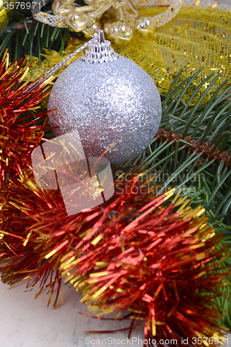 Image of Closeup of Christmas balls and green fir tree branch, new year invitation card