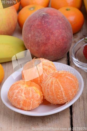 Image of Fresh colorful fruits composition mandarin, strawberry, peach, bananas and orange