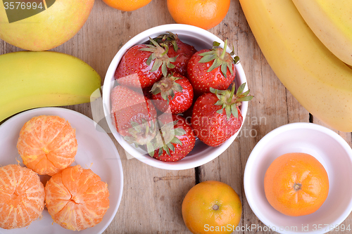 Image of Fresh colorful fruits composition mandarin, strawberry, peach, bananas and orange