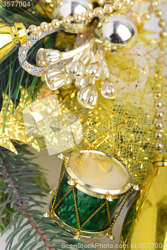 Image of Christmas background with drums, green eve tree branch, golden new year decoration 