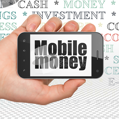 Image of Money concept: Hand Holding Smartphone with Mobile Money on display