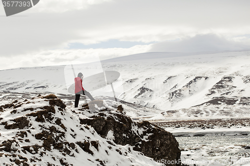 Image of Hiker at mountain top of waterfall Godafoss