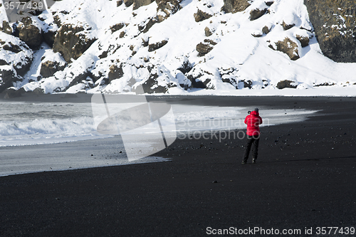 Image of Photographer at the black sand beach in Vik, Iceland