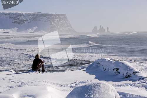 Image of Woman enjoys view o three pinnacles of Vik, Iceland