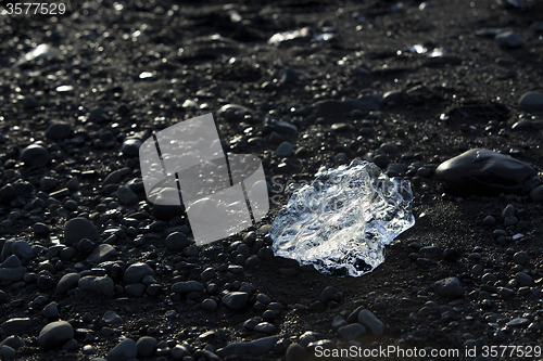 Image of Ice block on black sand beach at glacier lagoon Jokulsarlon, Ice