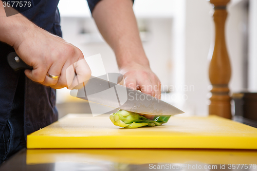 Image of Chef chopping greens