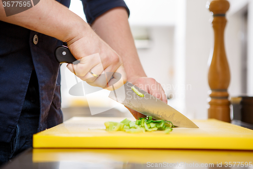 Image of Chef chopping greens