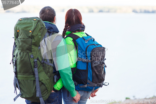 Image of woman and man standing relaxed on lake